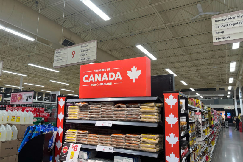 A photo of a fully stocked shelf at LCBO labeled with 'prepared in Canada for Canadians'.