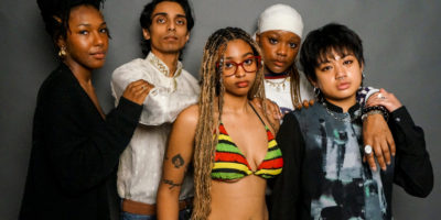 An image of multiple individuals standing in a group embrace