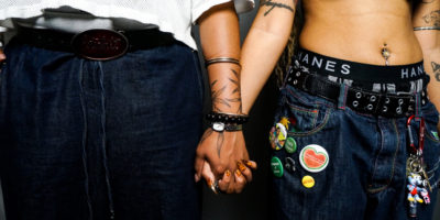 A picture of two individuals holding hands