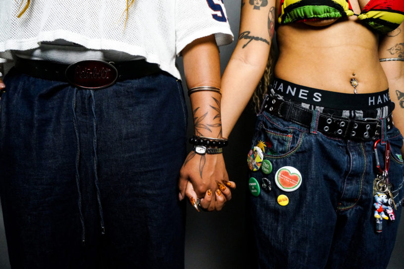 A picture of two individuals holding hands