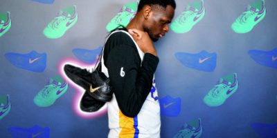 Photo of an athlete with shoes slung over his back over a decorated background with assets