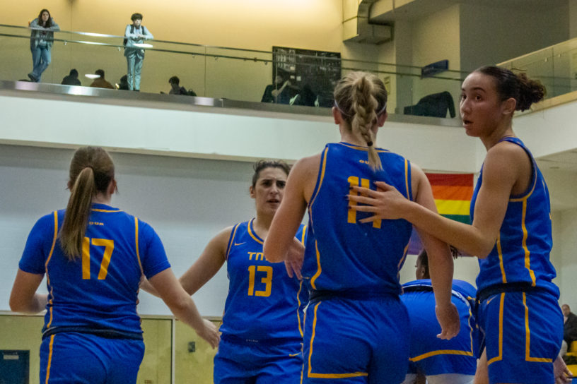 The TMU Bold women's going back to the centre of the court in a game against Carleton