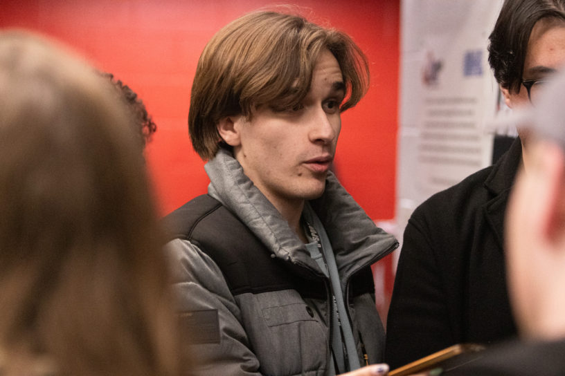 Mitchell Fox asking a question in a scrum interview