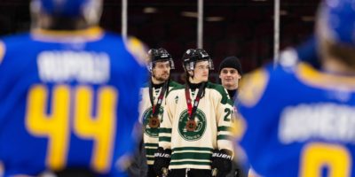 two Bold players looking at the bronze medal winners the huskies