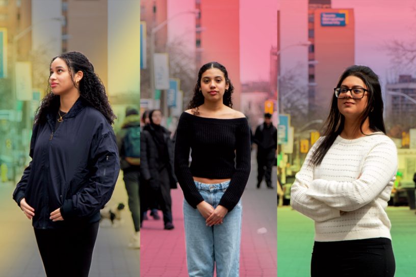 Three women standing in front of a dynamic colourful background.