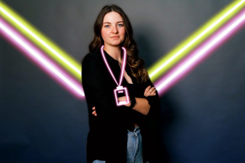 Woman standing on background with neon lines behind her