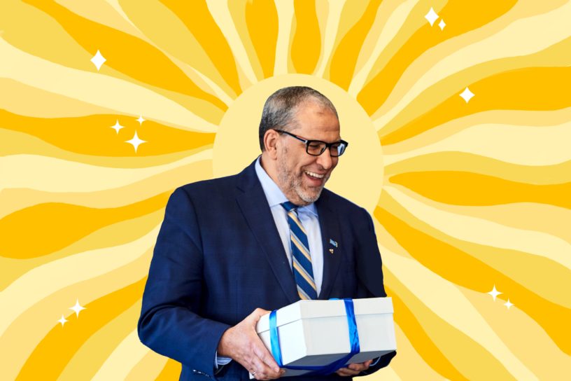 A photo of President Lachemi surrounded by an illustration of the sun beaming behind him.