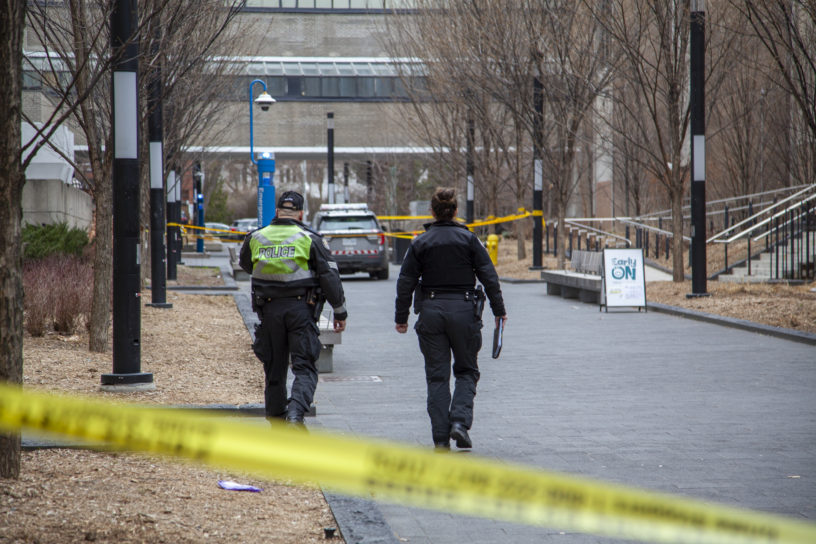 Police officers walking passing the caution tape onto the scene of the crime on Nelson Mandela Walk regarding the hit-and-run