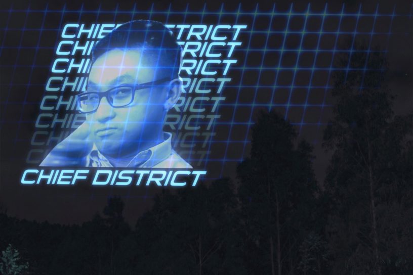 An illuminated blue hologram is projected onto the sky of a forest, featuring an image of Eyeopener Editor-in-Chief Joshua Chang