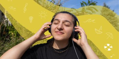 A girl with her hands on headphones listening to music, there are white illustrations in the background on top of a yellow stripe.