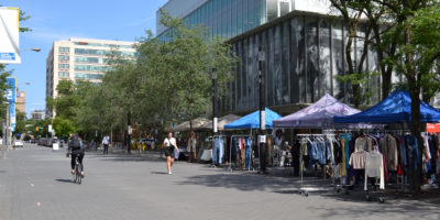 Photo of Gould Street with various tents and stands with different items.