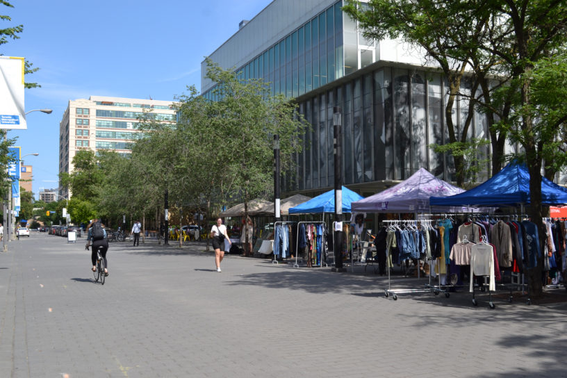 Photo of Gould Street with various tents and stands with different items.