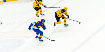 TMU and Waterloo players race across the ice