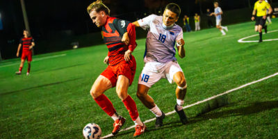 A TMU and Carleton player fight for the ball