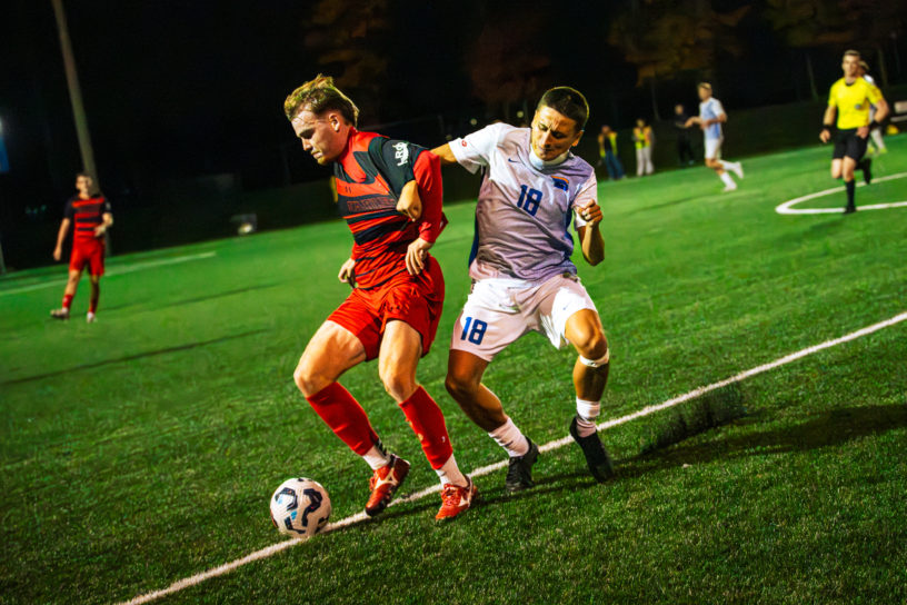 A TMU and Carleton player fight for the ball
