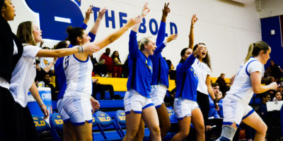 TMU's bench celebrates a three-pointer