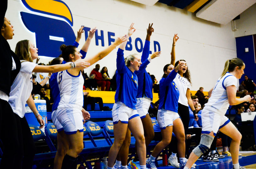 TMU's bench celebrates a three-pointer