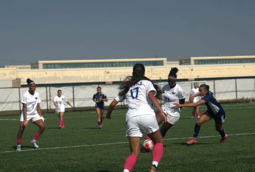 TMU gains possession of the ball amidst Laurentian defenders
