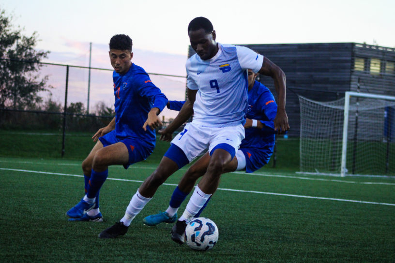 A TMU player maintains possession of the ball