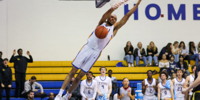 A TMU player dunks the ball