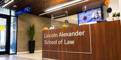 Image of a brown desk that reads "Lincoln Alexander School of Law".