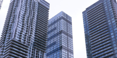 Image of three condos surrounded by sky.