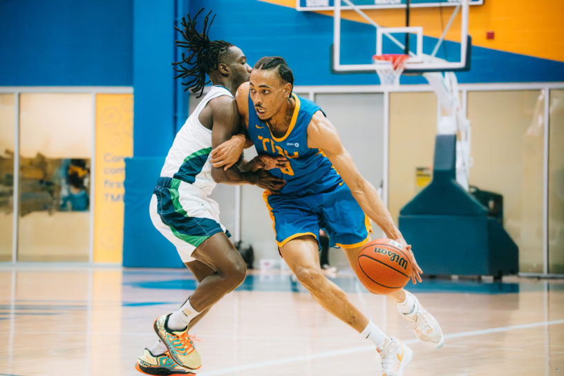 Deandre Goulbourne attacking a defender off the dribble at the Mattamy Athletics Centre