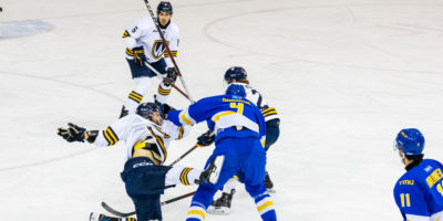 A scrum ensues on the ice