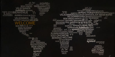 Image of a map of the world with text reading "welcome" in various languages.