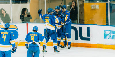 The TMU Bold men's hockey team celebrate a goal at the Mattamy Athletic Centre