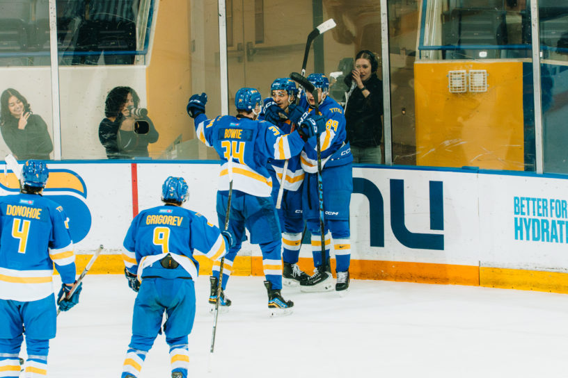 The TMU Bold men's hockey team celebrate a goal at the Mattamy Athletic Centre