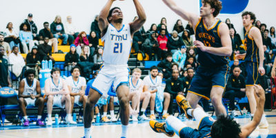 TMU attempts a shot amidst Queen's defence