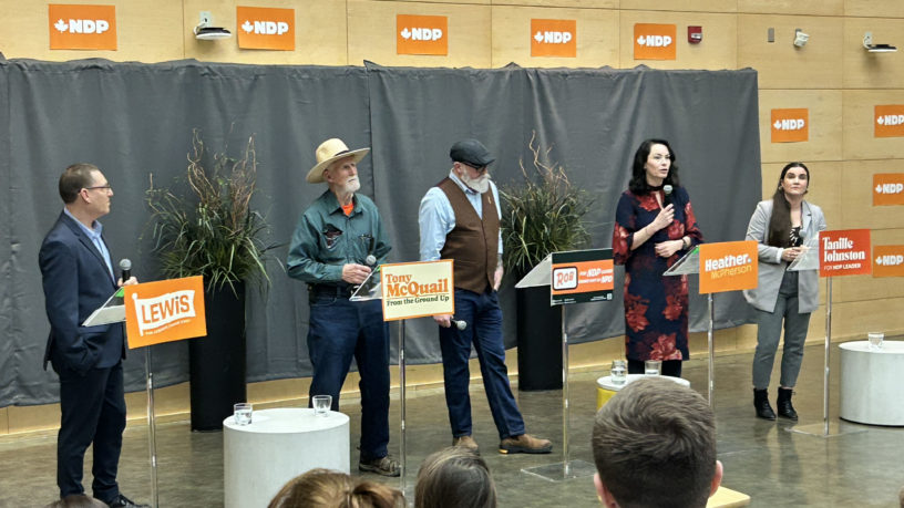 Avi Lewis, Tony McQuail, Rob Ashton, Heather McPherson and Tanille Johnson stand in front of a gray tarp.