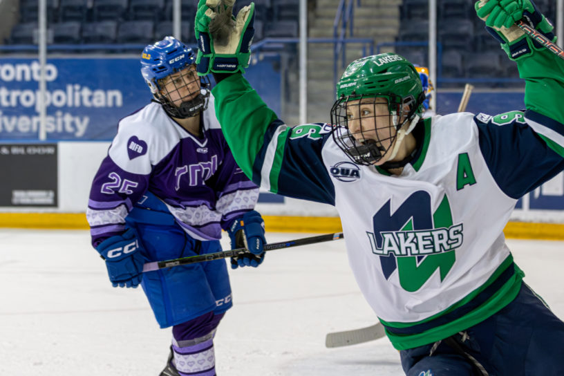 A Nipissing women’s hockey player celebrates a goal in front of a TMU player at the Mattamy Athletic Centre