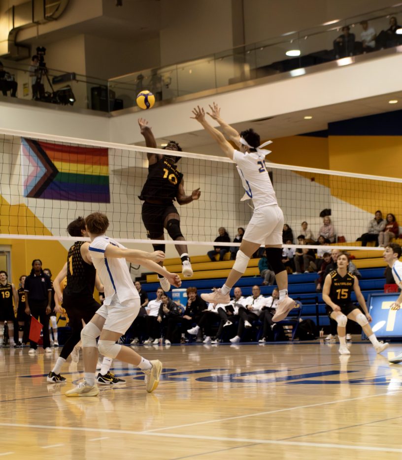 TMU tries to block a shot from Waterloo